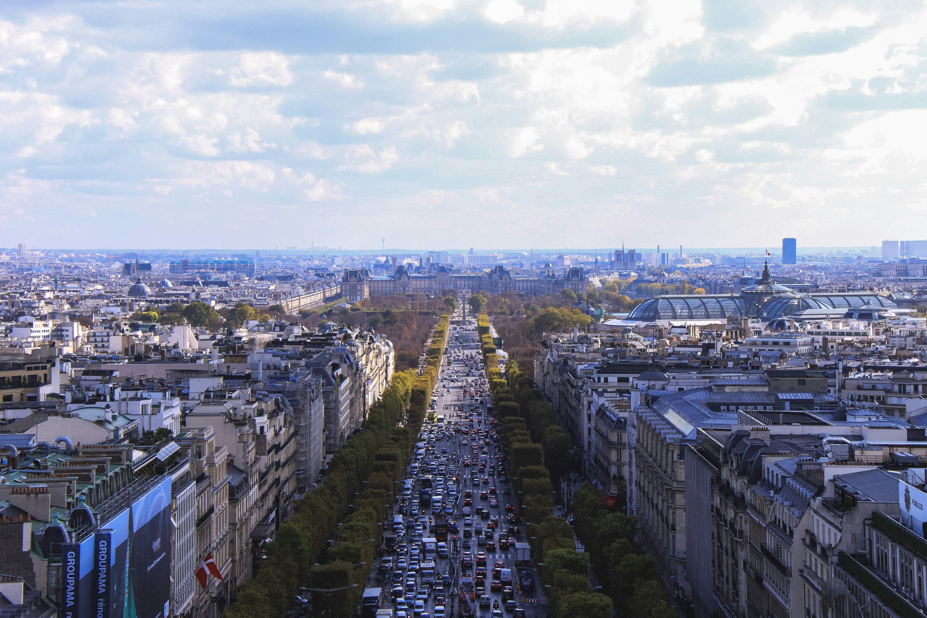 aerial photo of city under white clouds